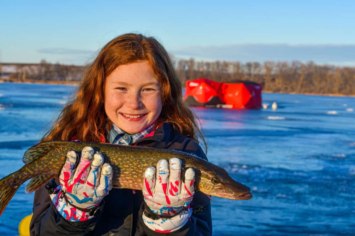 Daughter holding northern pike