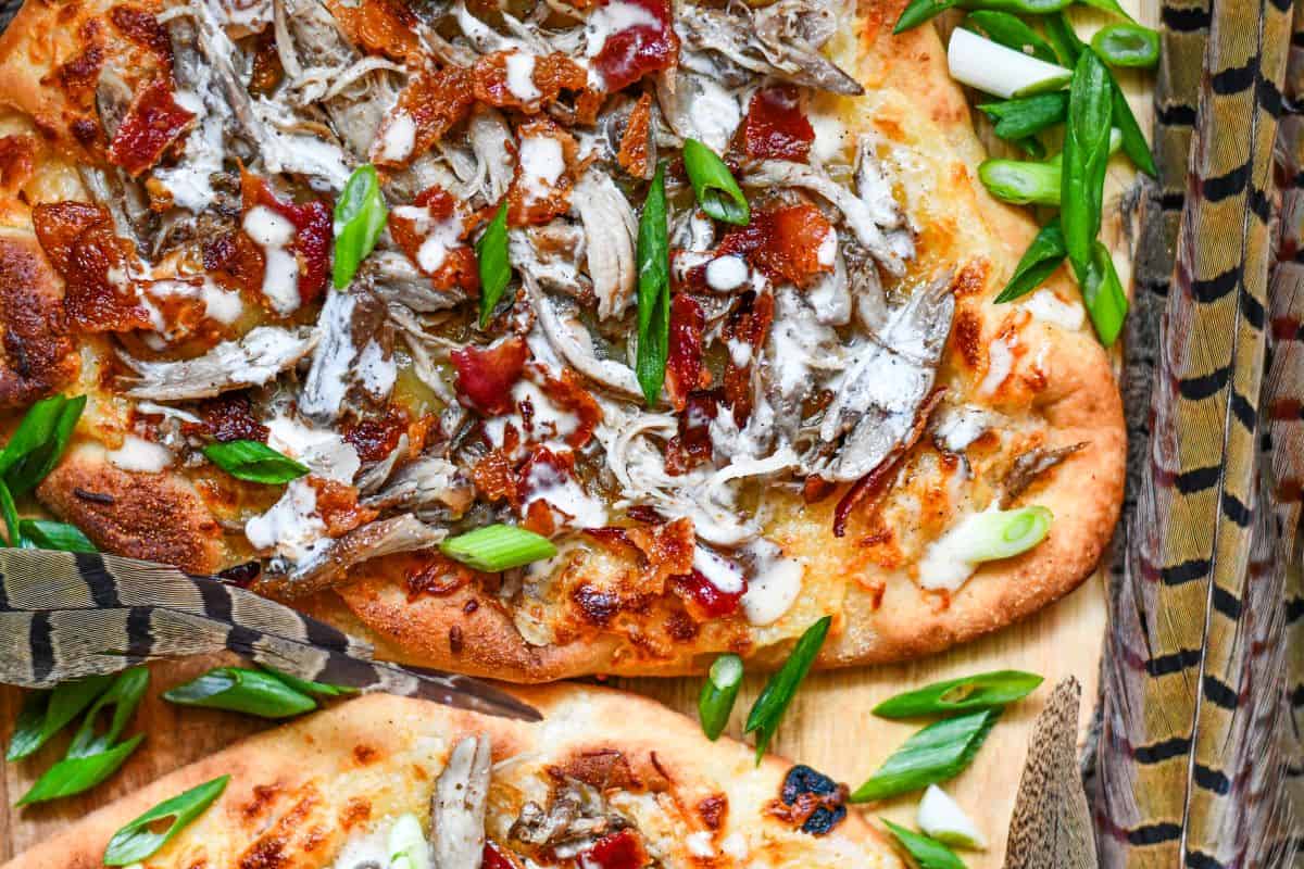 Pheasant Pizza. A great flatbread pizza recipe with bacon, cheese, green onions, and Alabama White Sauce.