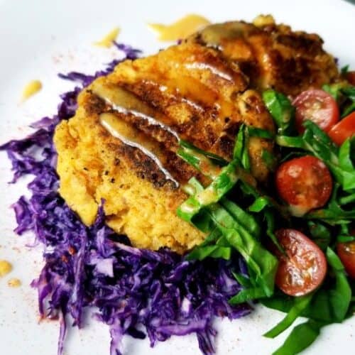 Potato Chip and Ricotta Cheese Fish Cakes over purple cabbage