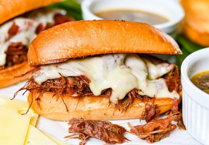 The Best French Dip Sandwiches with goose meat, melted cheese, and homemade au jus.