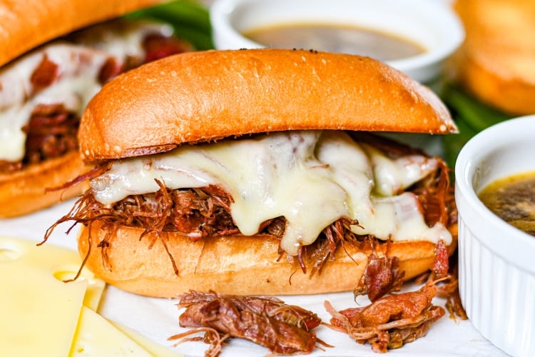 The Best French Dip Sandwiches with goose meat, melted cheese, and homemade au jus.