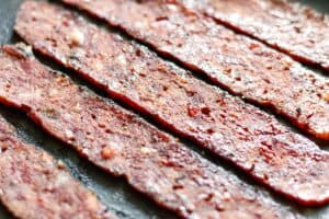 Venison Bacon Frying in a Skillet