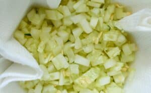 Diced cucumber in paper towels for Tzatziki sauce