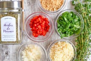 Stuffed Mushroom Ingredients including onion, bell pepper, baby spinach, asiago cheese, panko bread crumbs, fresh thyme, and Herbes de Provence.