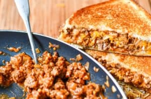 Sloppy Joe mix in pan with Sloppy Joe Grilled Cheese Sandwich