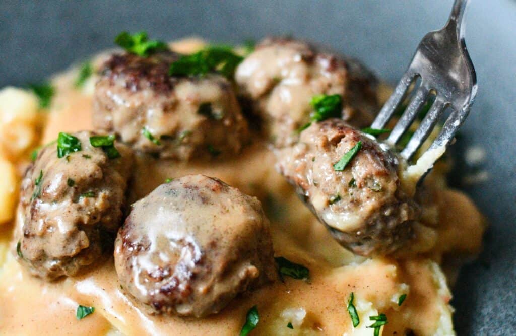 Venison Swedish meatballs and sauce served over mashed potatoes