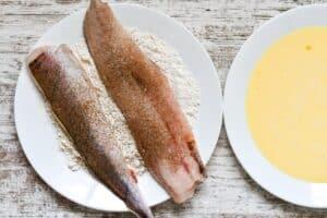 Whiting Fish seasoned with salt and black pepper dredged in flour, then egg and milk, and then potato flakes with Old Bay.