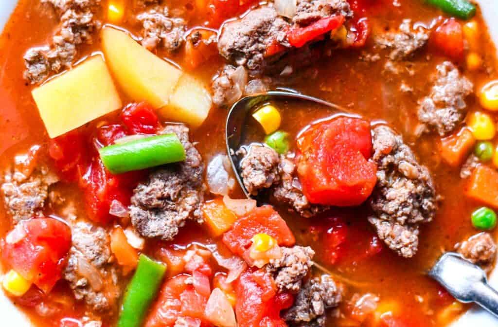 This Deer Burger Soup with mixed vegetables, potatoes, and tomatoes.