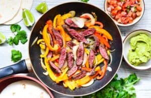 Goose Fajitas with goose breast, onions, peppers, tortillas, lime, pico de gallo, guacamole, and fresh cilantro.