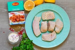 Lahori Fish recipe ingredients including paddlefish fillets, San Lahori fish seasoning, lemon, cilantro, red peppercorns, fennel seeds, and homemade tartar sauce