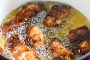 Pakistani Fried fish using Lahori battered paddlefish fillets in hot canola oil