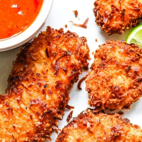 Crispy Coconut Crusted Fish with Easy Sweet Chili Sauce and garnished with lime wedges. I used American Paddlefish for this recipe, but you can use another firm white fish.