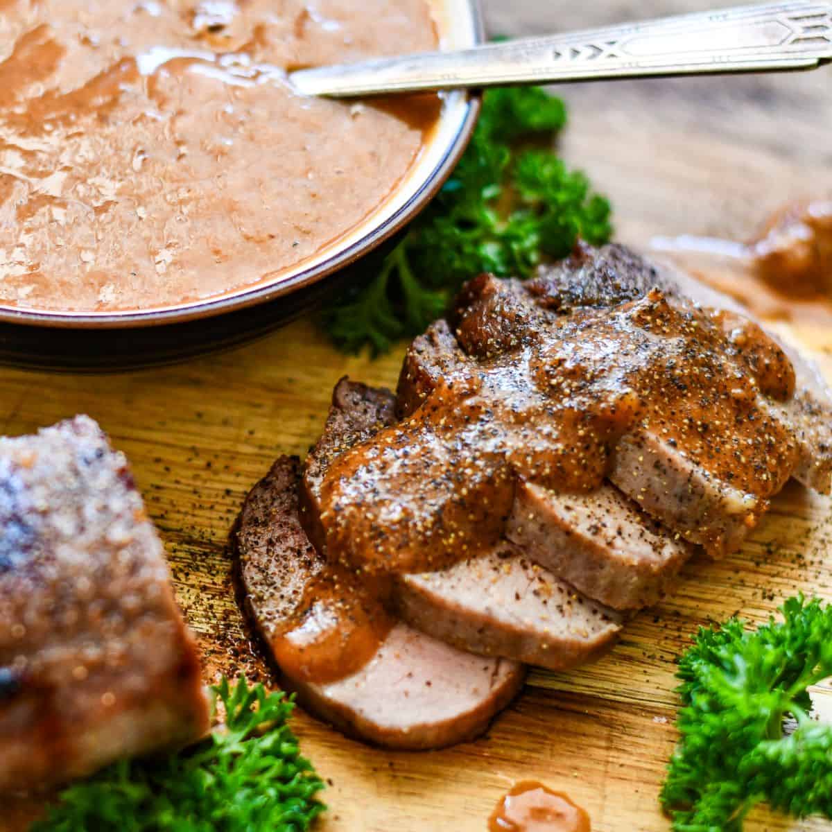 Homemade Steak Sauce on top of sliced venison eye of round steak