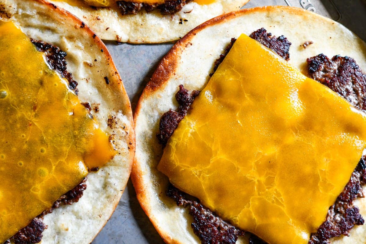 Ground Venison patties topped with slices of Sharp Cheddar Cheese