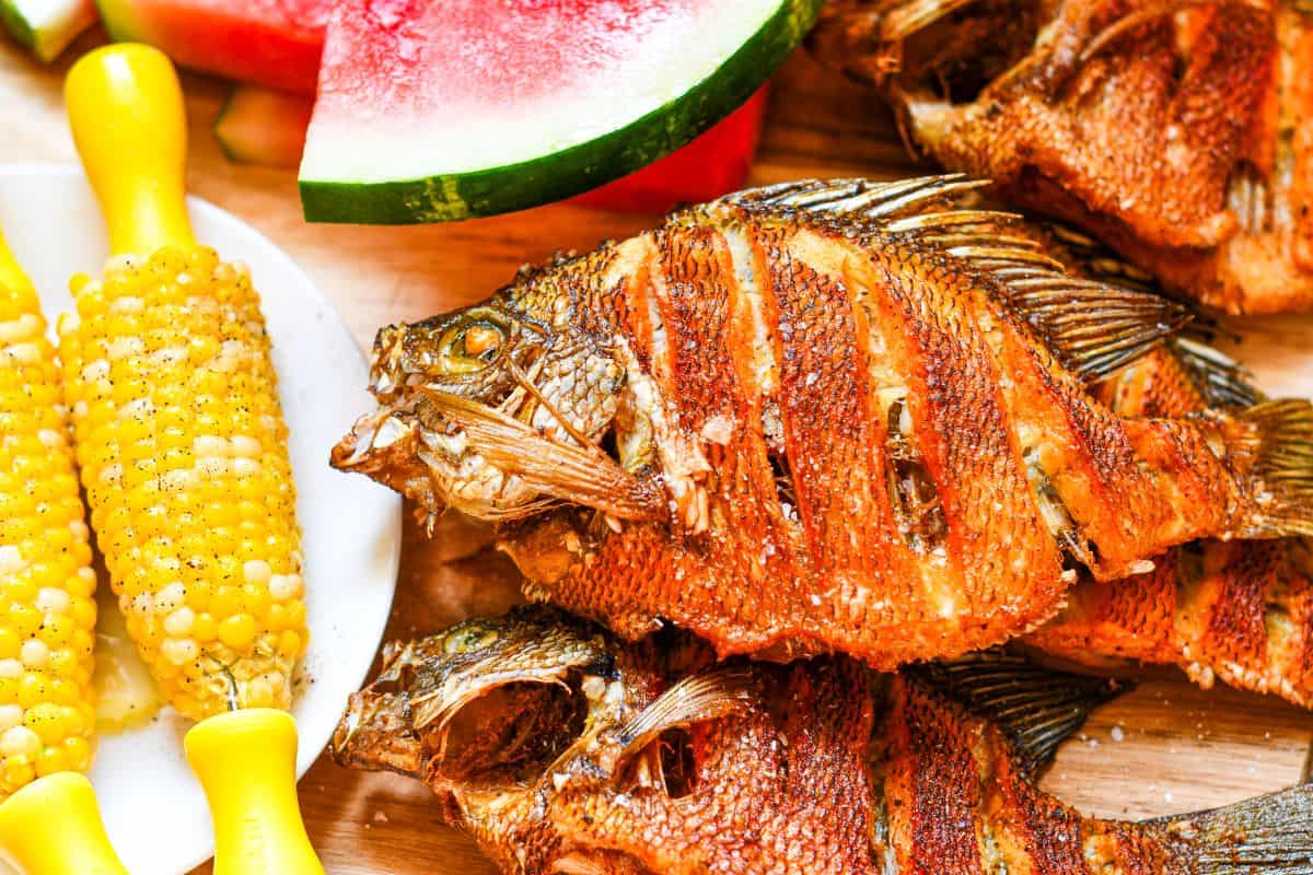 Fried Bluegill with corn on the cob and sliced watermelon