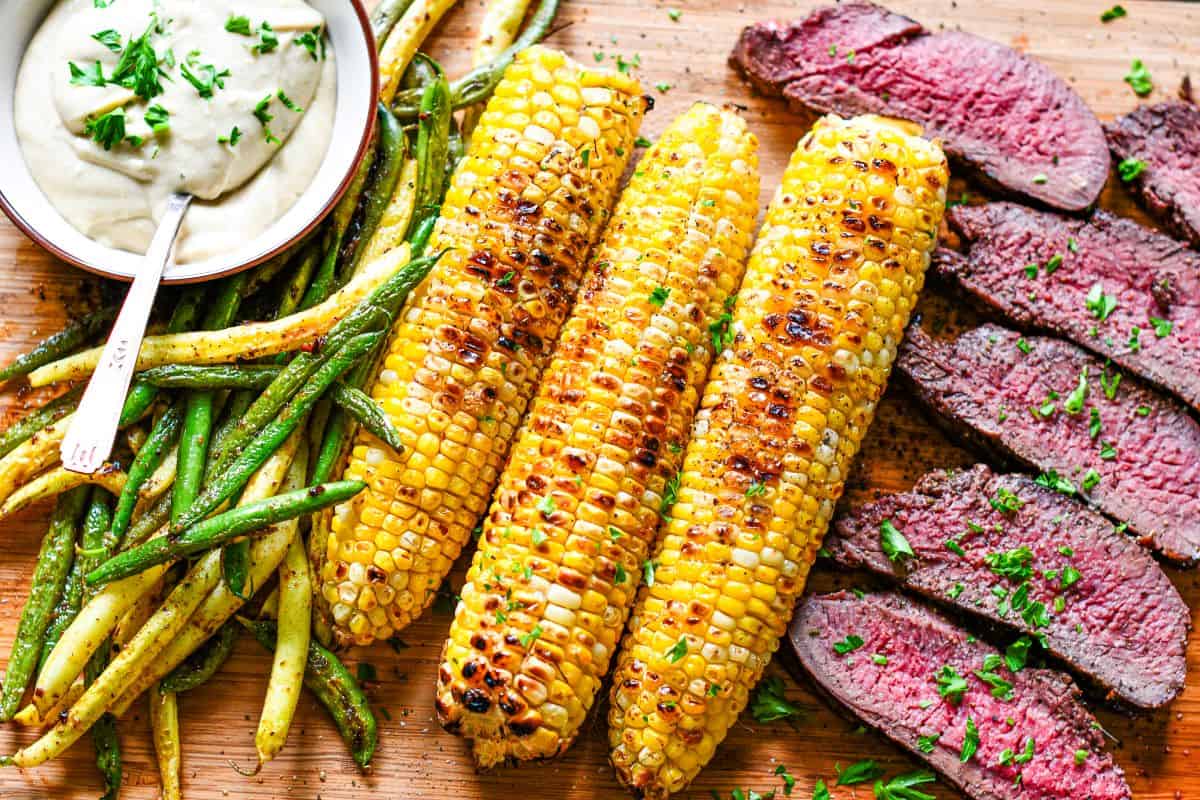 Grilled Venison Steak and Bernaise Sauce Recipe with corn on the cob and beans