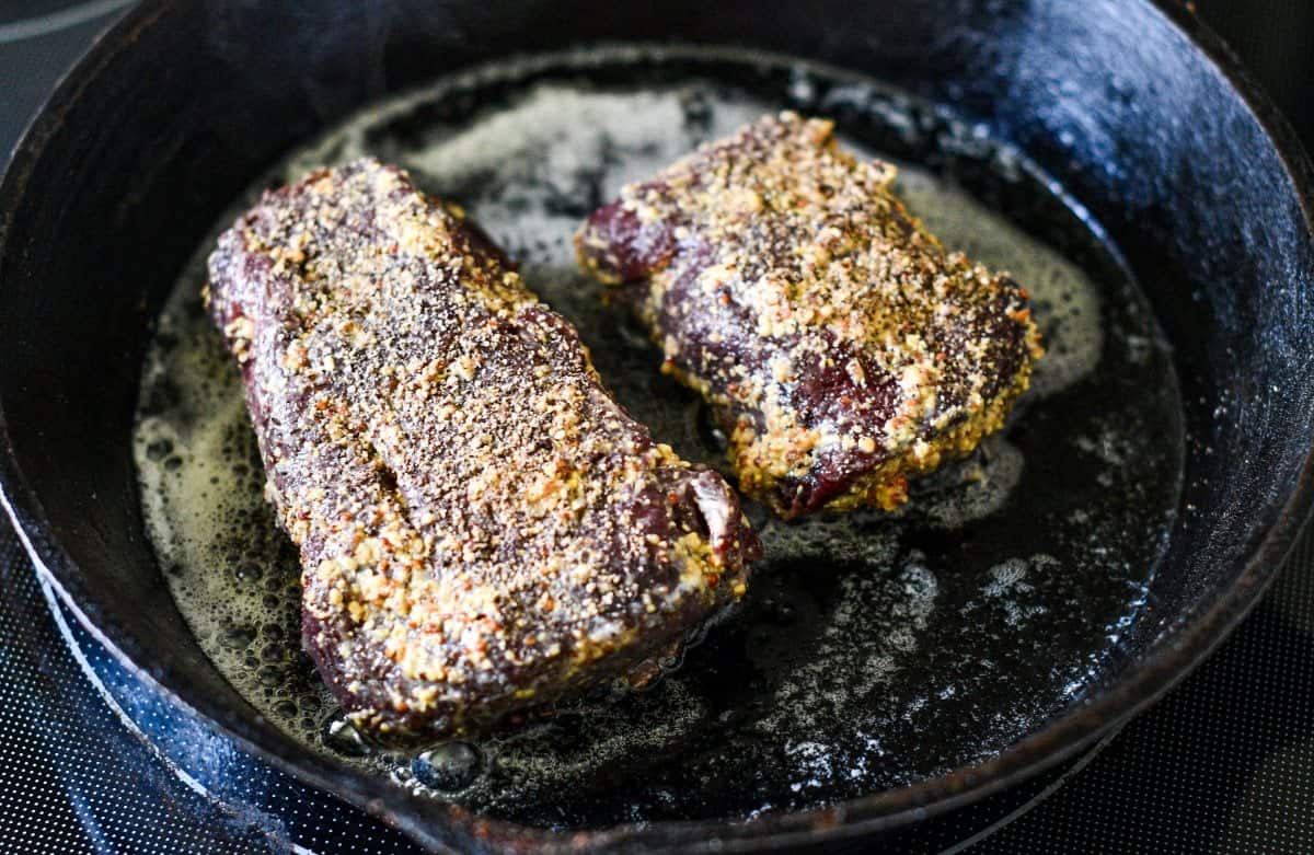 Cooking venison steak before slicing thin