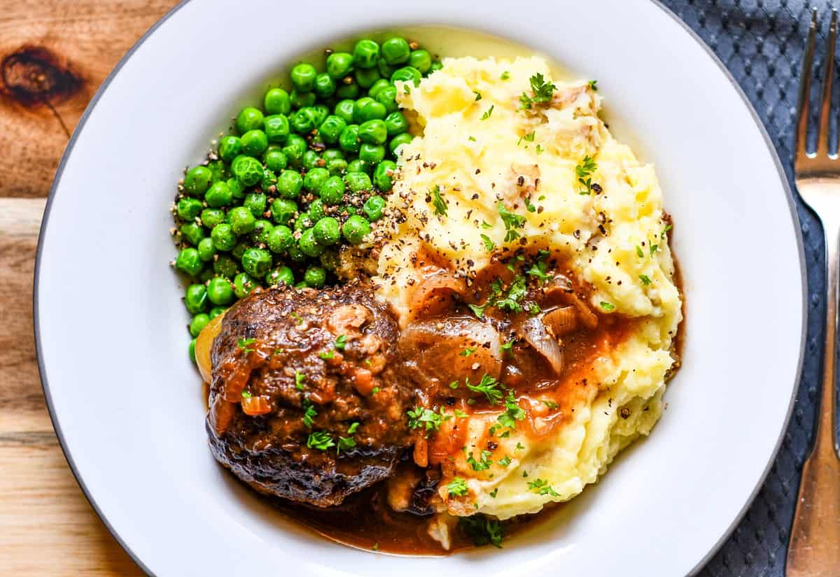 British Meatballs with Onion Gravy - Faggots. Served with Mashed Potatoes and Peas.