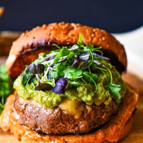 Tex Mex Big Game Burger topped with cheese, guacamole, microgreens, and Tex Mex mayonnaise