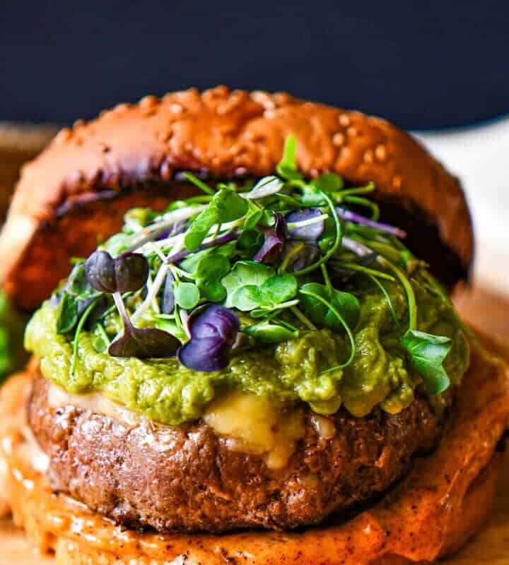 Tex Mex Big Game Burger topped with cheese, guacamole, microgreens, and Tex Mex mayonnaise