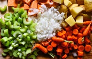 Duck Soup ingredients including yellow onion, celery, carrots, potatoes, and sweet potatoes