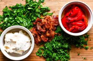 Turkey Roulade Filling of vegetable cream cheese spread, fresh spinach, fresh parsley, roasted red peppers, and cooked bacon