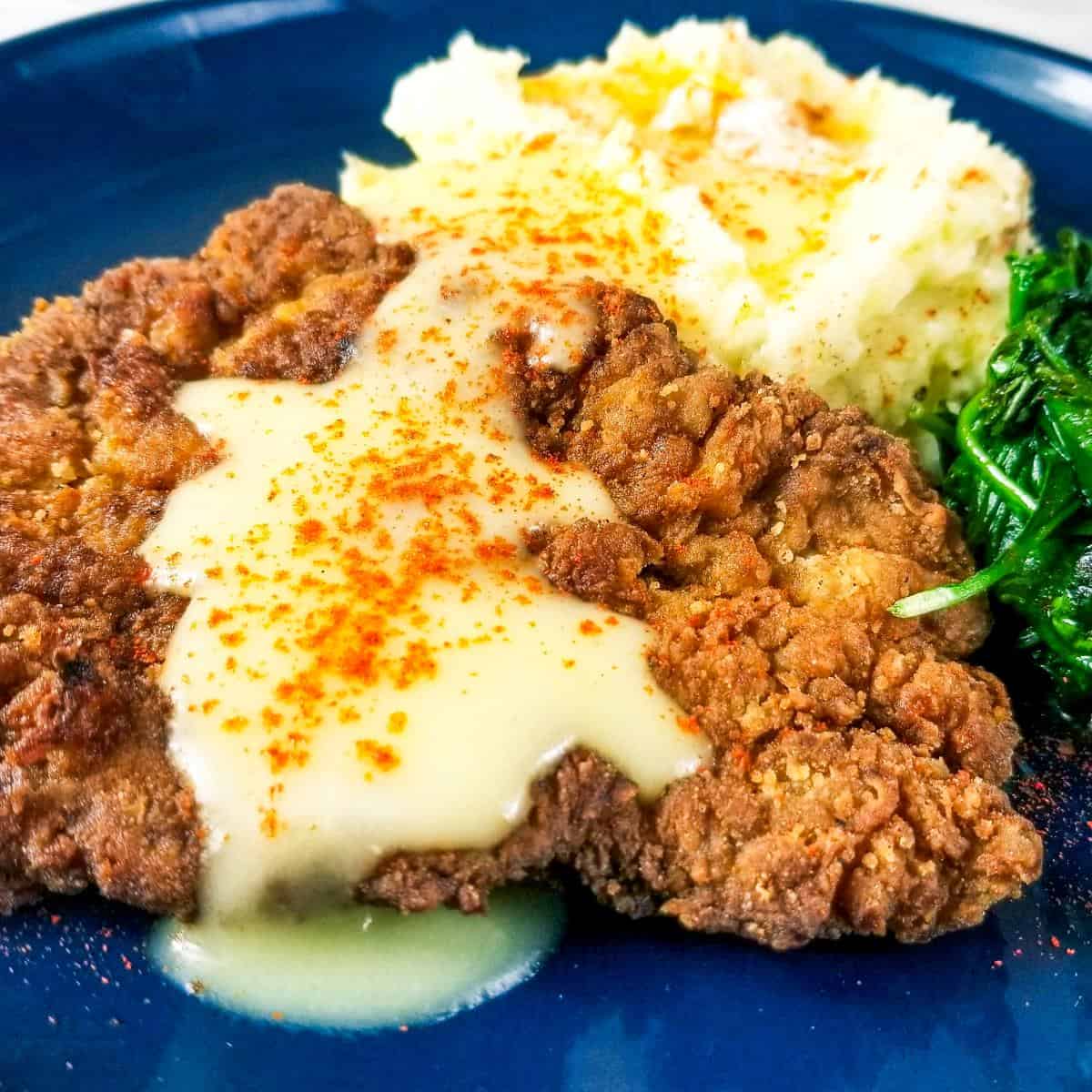 Country Fried Venison Steak (Venison Cube Steak Recipe) with Mashed Potatoes and Gravy and Sauteed Spinach