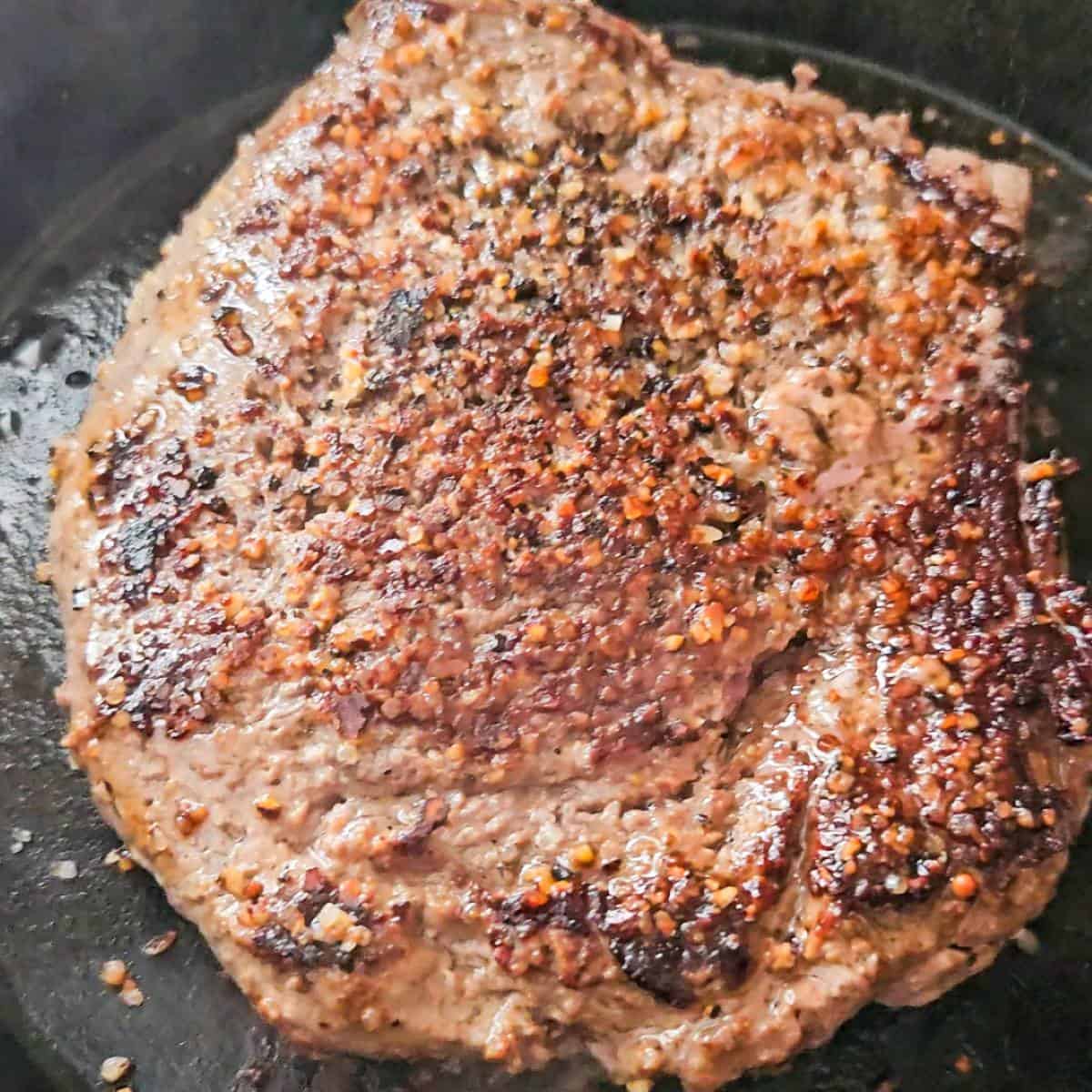 Deer Steak seasoned with kosher salt for Steak and Eggs