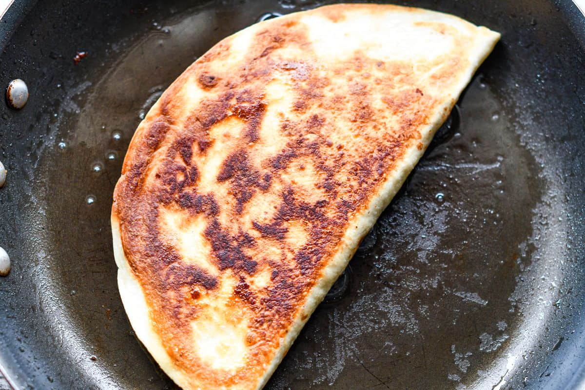 Tortilla folded over for skillet quesadilla