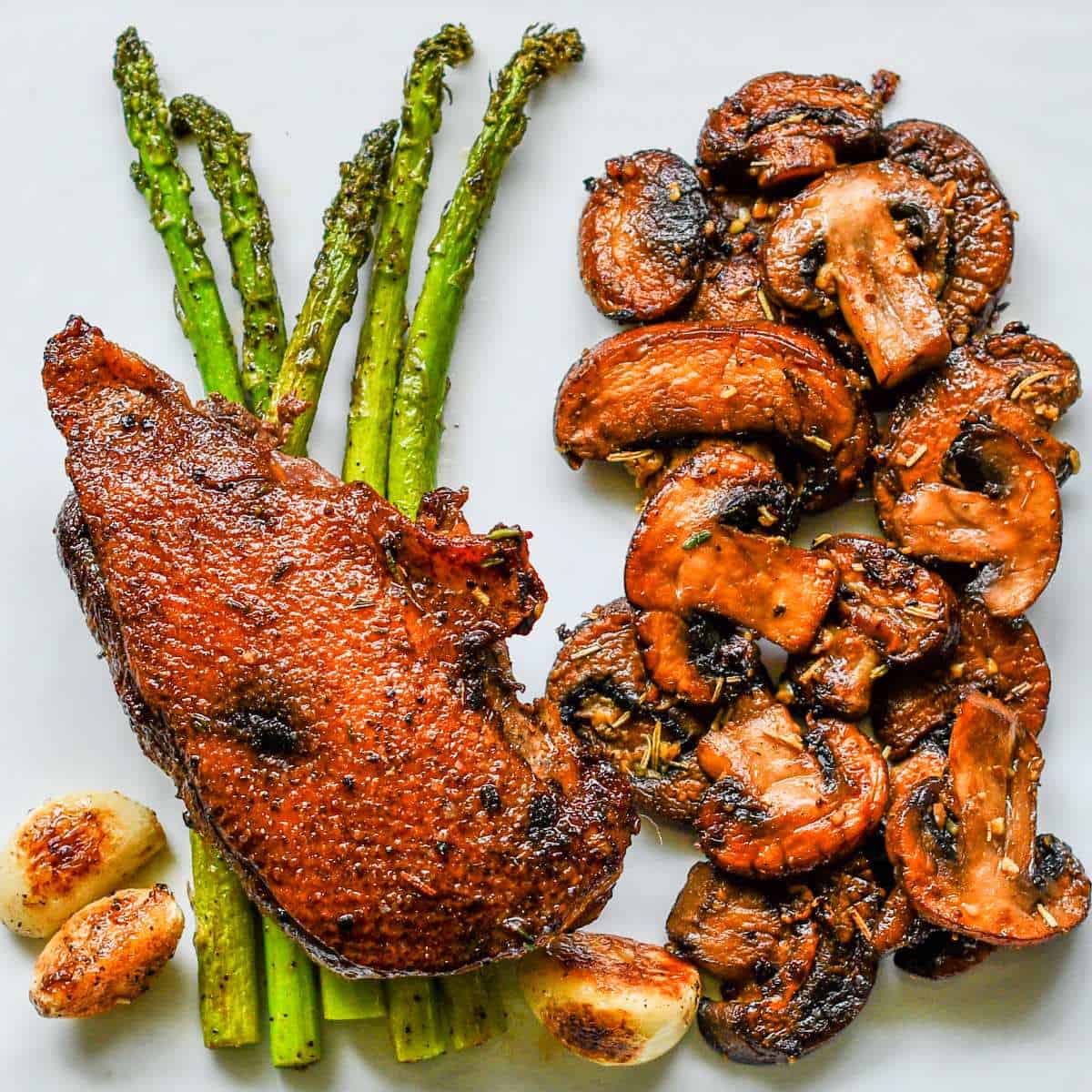 Crispy Duck Breast with Garlic Herb Butter Mushrooms and Asparagus