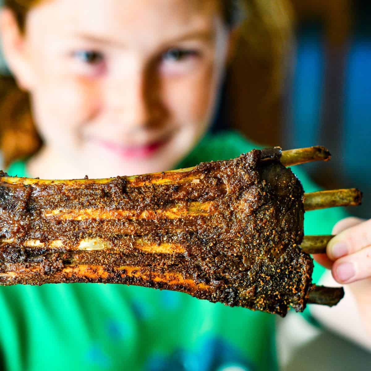 Dutch Oven Deer Ribs held by Jeff Benda's daughter